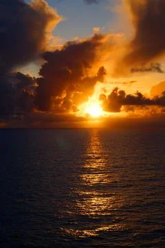Dramatic Sunset Over the Sea With Cinematic Clouds and Reflections Stock Photos