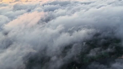 Dramatic Sunset Over a Sea of Clouds Captured from Above Видео 336662562