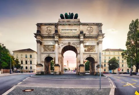 Dramatic sunset over Siegestor - Victory Gate  arch in downtown Munich, Germa Stock Photos