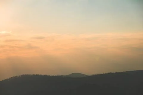 Dramatic sunset over silhouetted ridges in the Beskydy Mountains, Czechia 스톡 사진