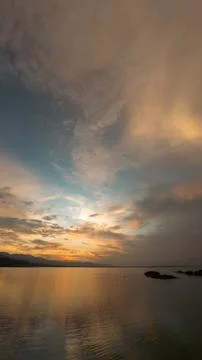Dramatic Sunset Over Still Lake Water Stock Photos