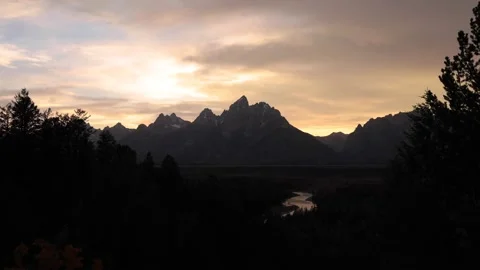 Dramatic Sunset Over Teton Mountains With River In Foreground Video stock 145821918