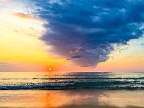 Dramatic Sunset over Tranquil Ocean Waves Stock Photos