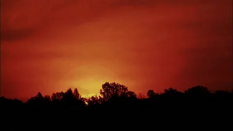 Dramatic Sunset Over Tree Line with Fiery Sky Stock Footage 327266292