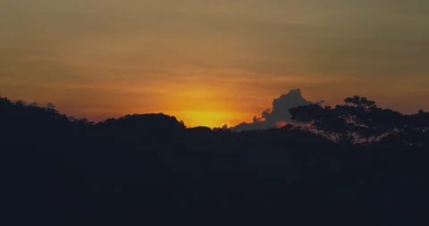 Dramatic Sunset Over Tropical Jungle with Layered Mountain Silhouettes Video stock 332268143