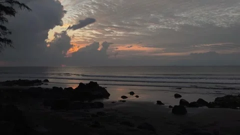 Dramatic Sunset Over Volcanic Rocky Beach With Dramatic Clouds and Ocean Waves Stock Footage 343877312