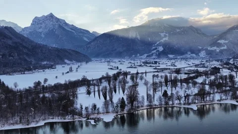 Dramatic sunset over Walensee with mountains from drone. Golden light above Stock Footage 330919024