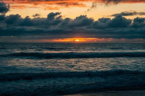 Dramatic sunset over waves in the Pacific Ocean in Imperial Beach, near San D Stock Photos