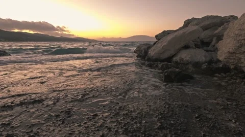 Dramatic Sunset Over Wavy Ionian Sea and Rocky Coastline in Alykanas, Greece Stock Footage 328304757