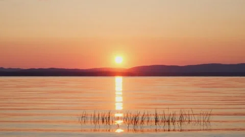 Dramatic sunset overlooking the lake. Golden hour, mirror reflection. Stock Footage 243701242
