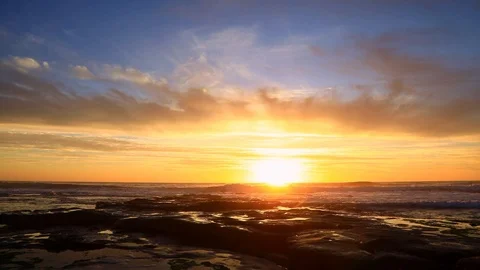 Dramatic Sunset overlooking rough waves and rock pools near Kommetjie Cape To Stock Footage 121604560