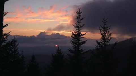 Dramatic sunset paints sky with vibrant hues of orange, pink, and purple Stock Footage 293943393