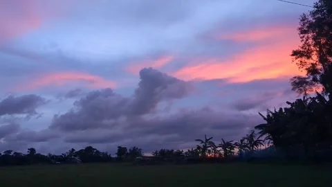 Dramatic sunset paints the sky with vibrant colors over a tranquil landscape 스톡 동영상 320093785