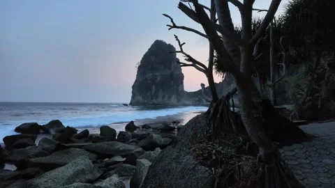 Dramatic sunset at Pangasan Beach, Pacitan, Indonesia, with crashing waves Stock Footage 347120530