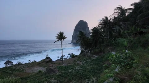 Dramatic sunset at Pangasan Beach, Pacitan, Indonesia, with crashing waves Stock Footage 347120585