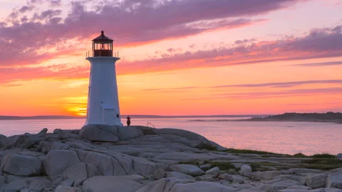 Dramatic sunset at Peggy's Cove Lighthouse Atlantic Coast Nova Scotia Canada Video stock 136583886
