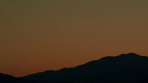 Dramatic Sunset Rays Behind Silhouette Of Mountain. Gradient Vivid Nature Stock Photos