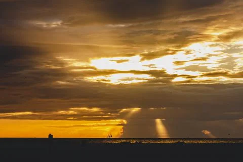 Dramatic sunset with rays of light and clouds Stock Photos