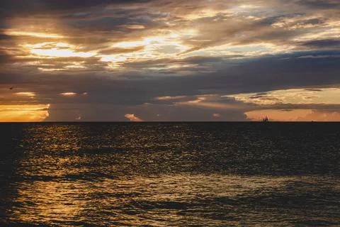 Dramatic sunset rays of light through clouds and horizon 스톡 사진