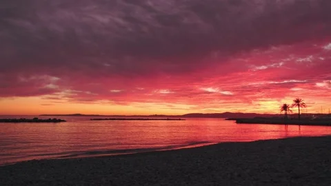 A dramatic sunset with red clouds over the beach. Stock Footage 229943877