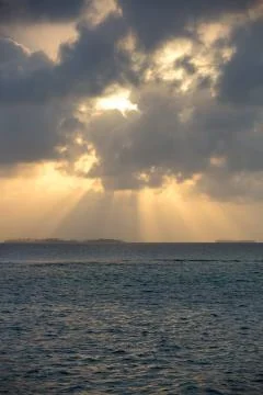 Dramatic sunset on a remote paradisiac island Stock Photos