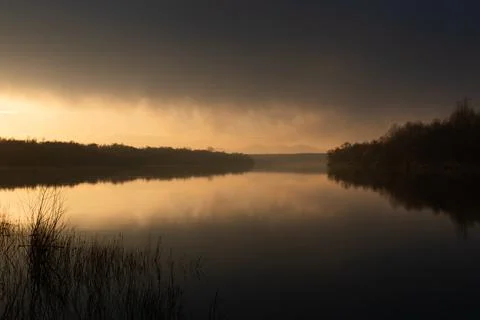 Dramatic sunset on river Sava and mountain Motajica in mist Foto stock