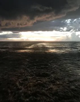 Dramatic sunset scene at the ocean Stock Photos