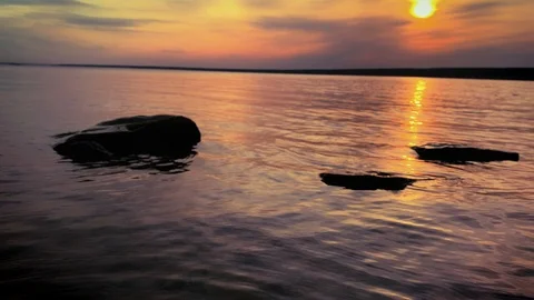 Dramatic sunset in the sea against the backdrop of mountains. 4K 60 fps footage. Stock Footage 108663642