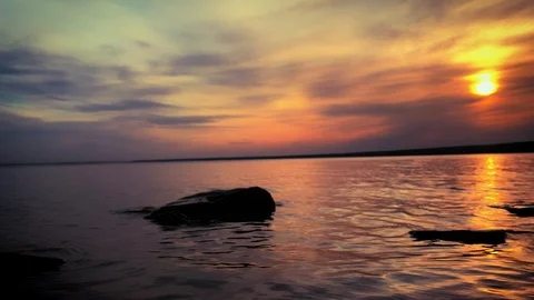 Dramatic sunset in the sea against the backdrop of mountains. 4K 60 fps footage. Stock Footage 108663664