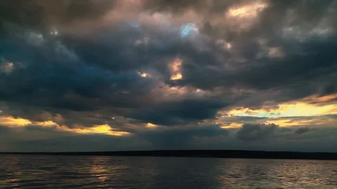 Dramatic sunset in the sea against the backdrop of mountains. 4K 60 fps footage. Stock Footage 108664189