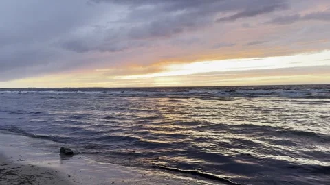 Dramatic sunset at sea with beach and rolling waves Video stock 332661872