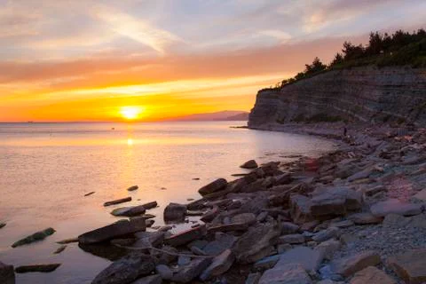 Dramatic sunset on the sea coast in the area of Gelendzhik resort Orange sun set Stock Photos