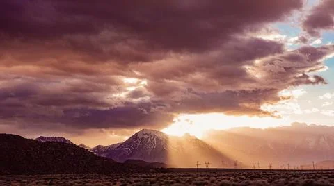 Dramatic sunset in Sierra Nevada's rays of light and clouds 写真素材