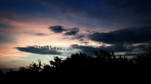 Dramatic Sunset with Silhouetted Trees and Colorful Clouds. 4K Video Stock Footage 275590808