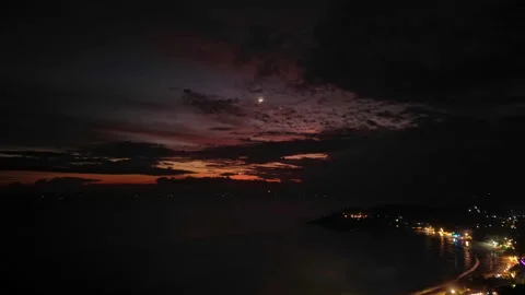 Dramatic sunset skies evolve in fast-motion over coastal cityscape. Dusk light Stock Footage 261028187