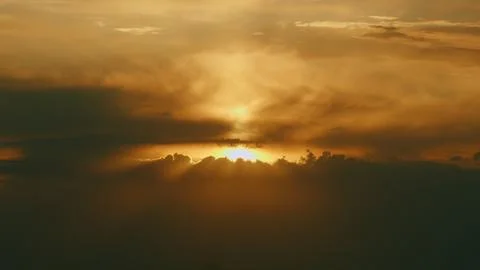 Dramatic sunset sky background. Beautiful sun at sunset. Pan. Stock Photos