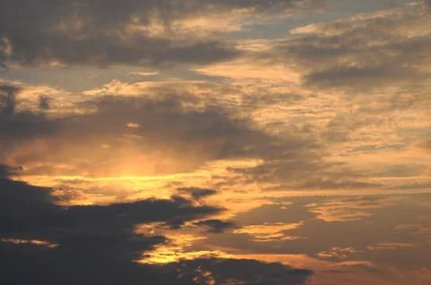 Dramatic sunset sky background with fiery clouds Stock Photos