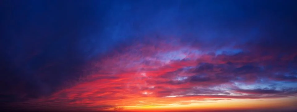 Dramatic sunset sky background. Panorama of twilight sky with clouds. Stock Photos