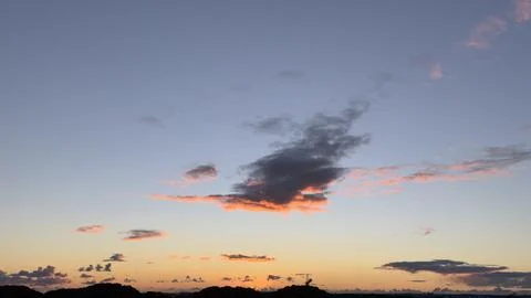 Dramatic sunset sky with beautiful blue, orange, and pink clouds above a si.. Stock Photos