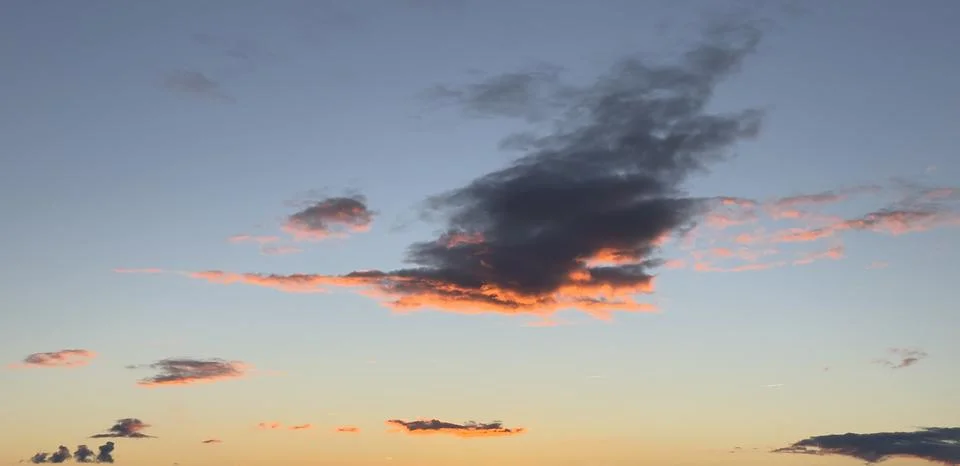 Dramatic sunset sky with beautiful blue, orange, and pink clouds above a si.. Stock Photos