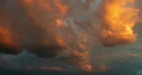 Dramatic sunset sky with beautiful golden and orange cumulus clouds time lapse Stock Footage 340397146
