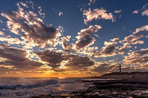 Dramatic sunset sky with clouds and reflection on the sea. A black and white Stock Photos