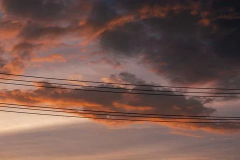 Dramatic Sunset Sky with Clouds and Wires 스톡 사진