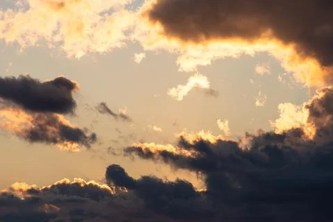 Dramatic sunset sky of clouds covering yellow sky. Stock Photos