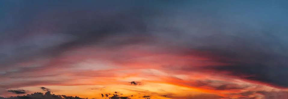 Dramatic sunset sky with clouds. Natural panorama of sky at dusk. Stock Photos