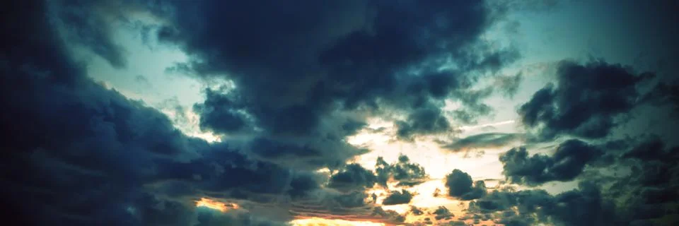 Dramatic sunset sky with clouds. Stock Photos