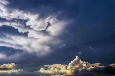 Dramatic sunset sky with colorful clouds after thunderstorm Stock Photos