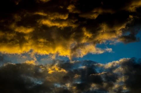 Dramatic sunset sky with colorful clouds after thunderstorm Stock Photos
