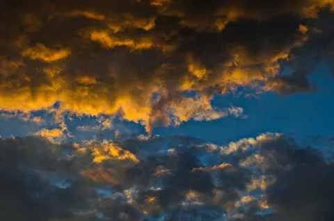 Dramatic sunset sky with colorful clouds after thunderstorm Stock Photos