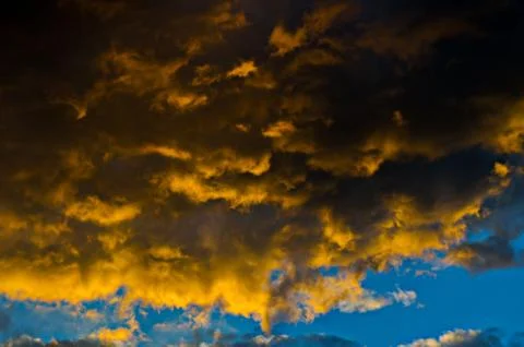 Dramatic sunset sky with colorful clouds after thunderstorm Stock Photos